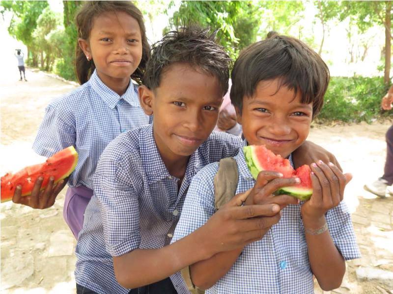 Indian kids eating watermelon on IVI project