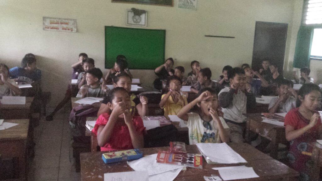 teaching children how to floss in bali