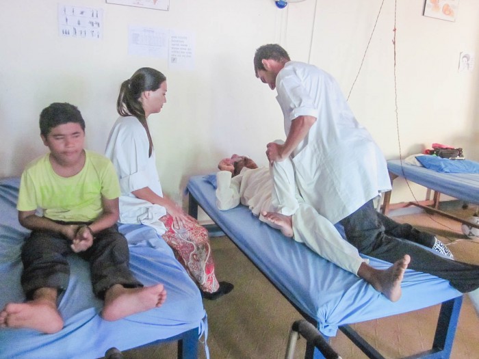 Physiotherapist intern assisting person in nepal