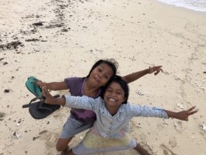 children smiling on beach in fiji remote island