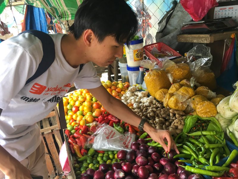 IVI volunteer at market stool in Philippines