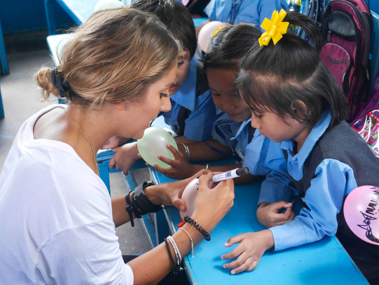 IVI Volunteer teaching Nepalese Children