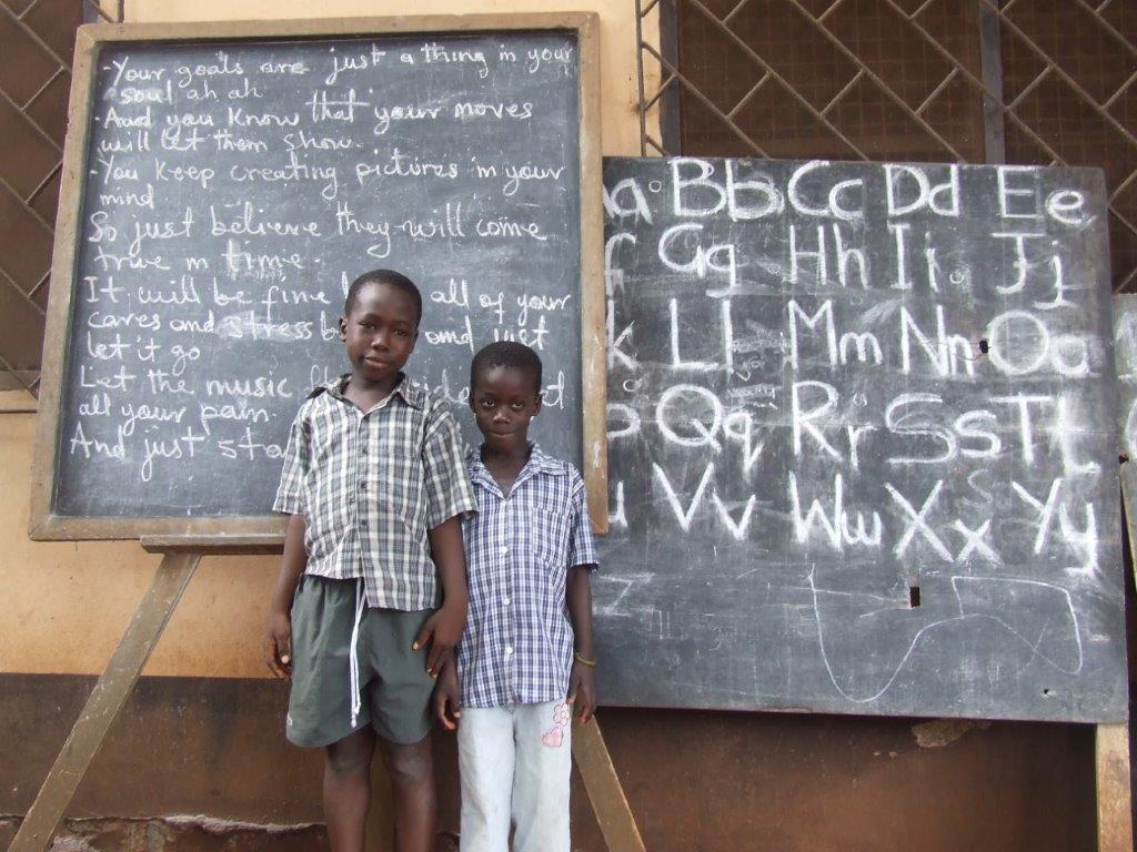 young boys in front of chalkboard