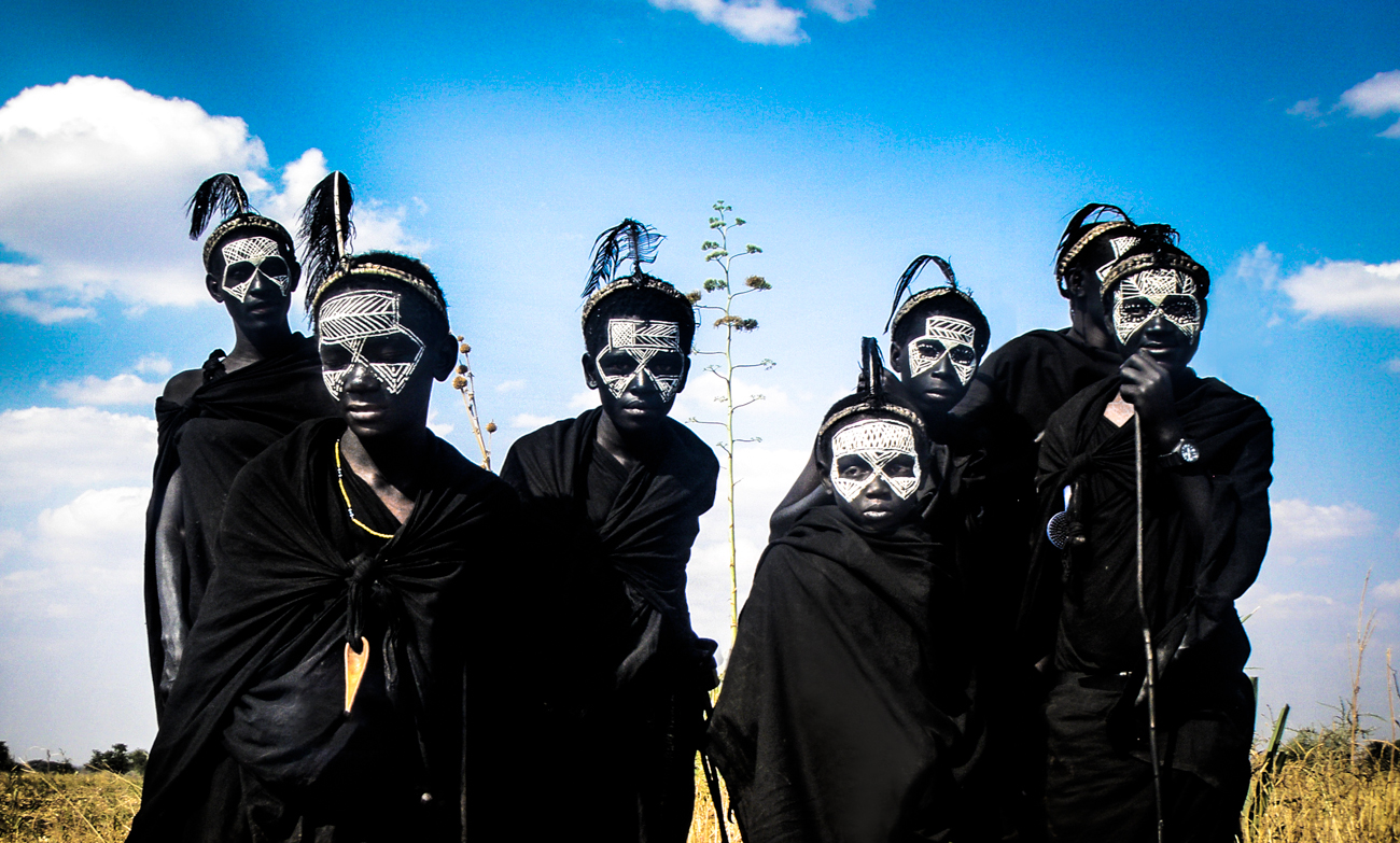 Maasai kids with black and white painted faces