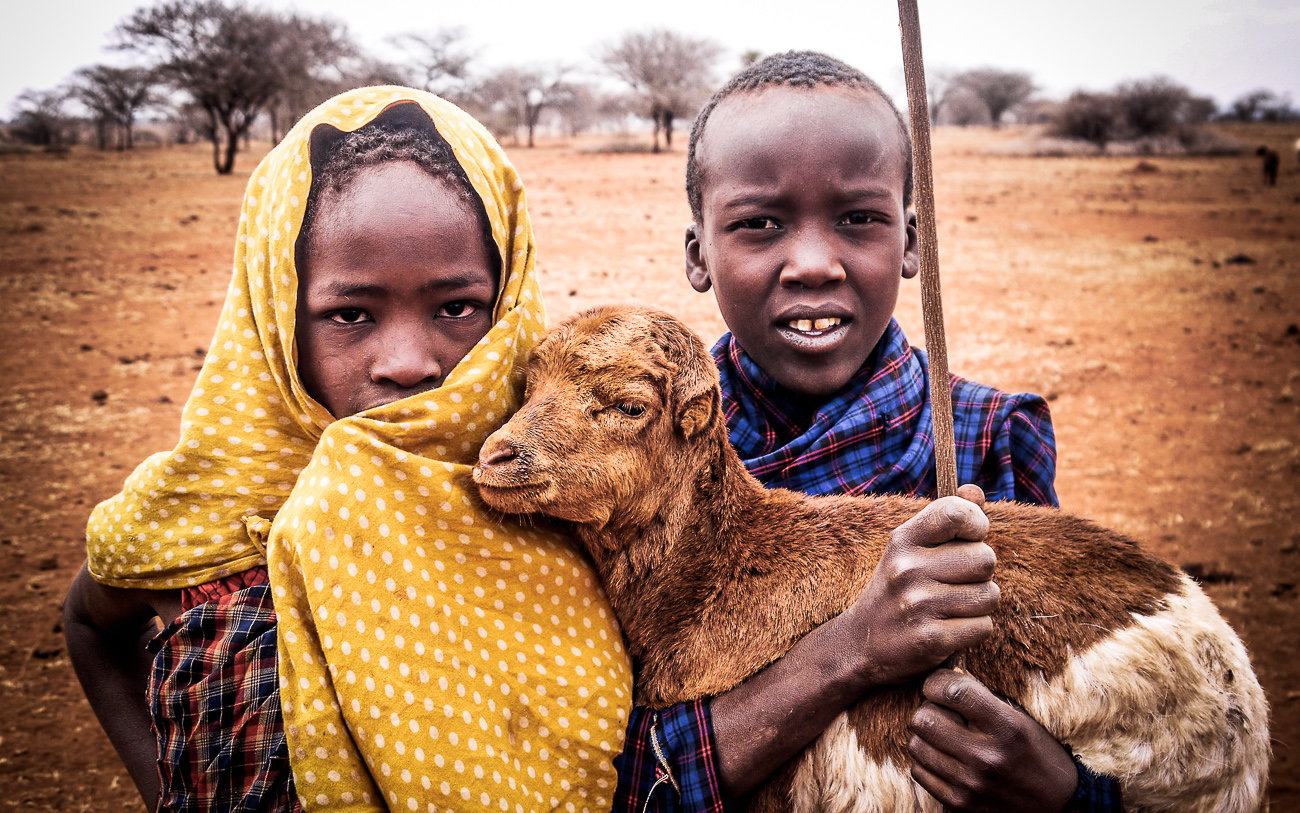 children with baby goat