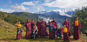 group of monks with mountain backdrop