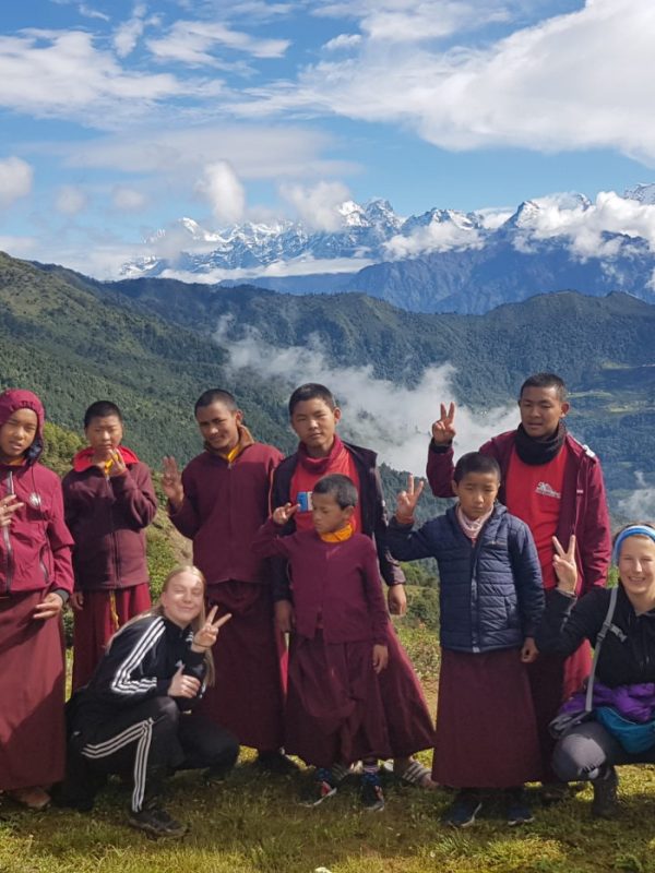 group of monks with mountain backdrop