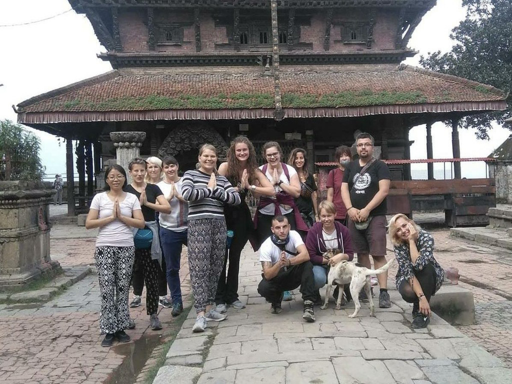 group pic by temple in Nepal