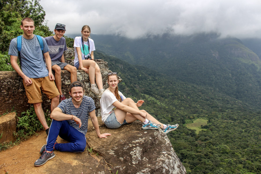 group sitting at top of viewpiont