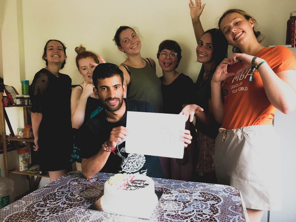 group standing around birthday cake