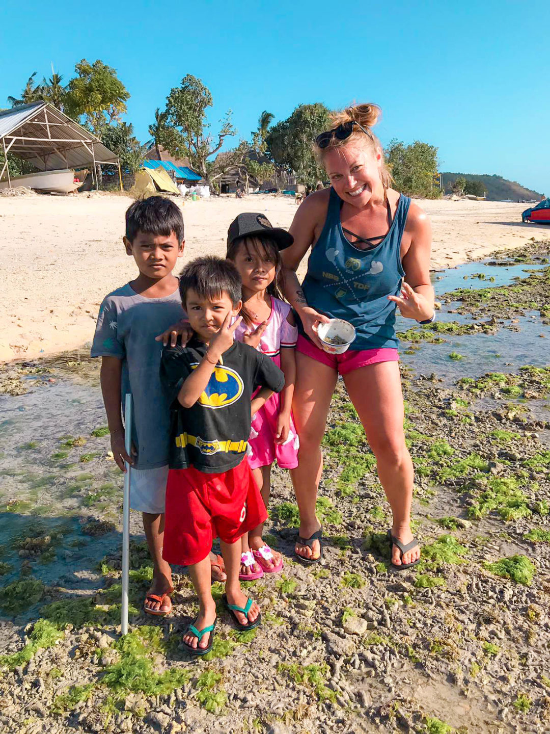 posing with local children at the beach