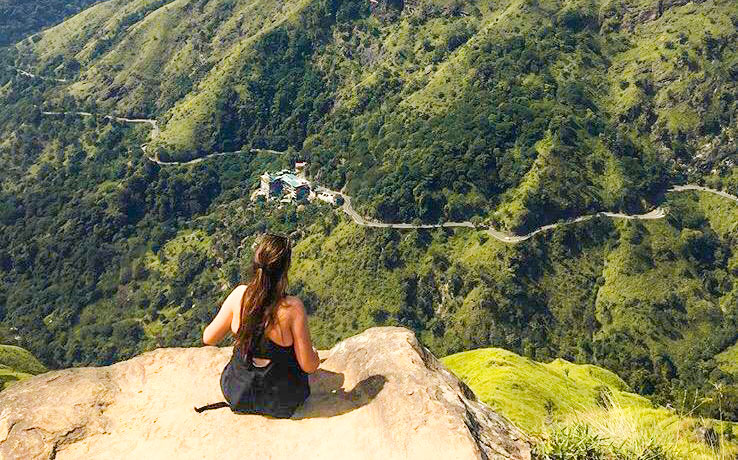 sitting on a rock overlooking green countryside