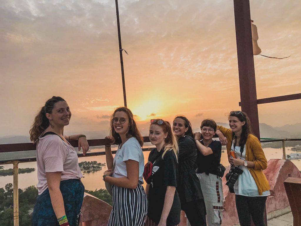 volunteers in front of sunset in India