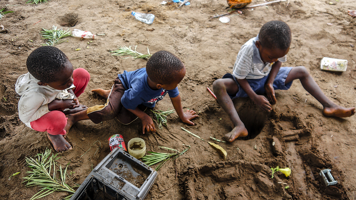 young boys playing with mud