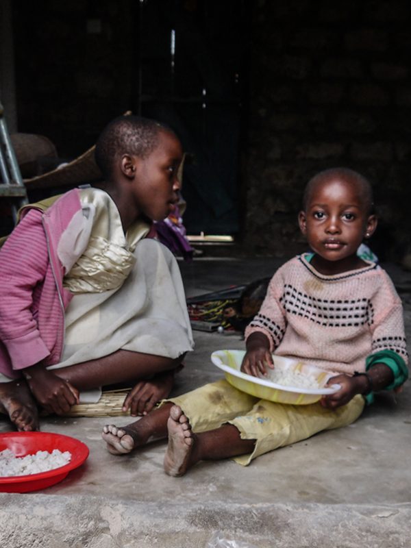 young kids eating on floor