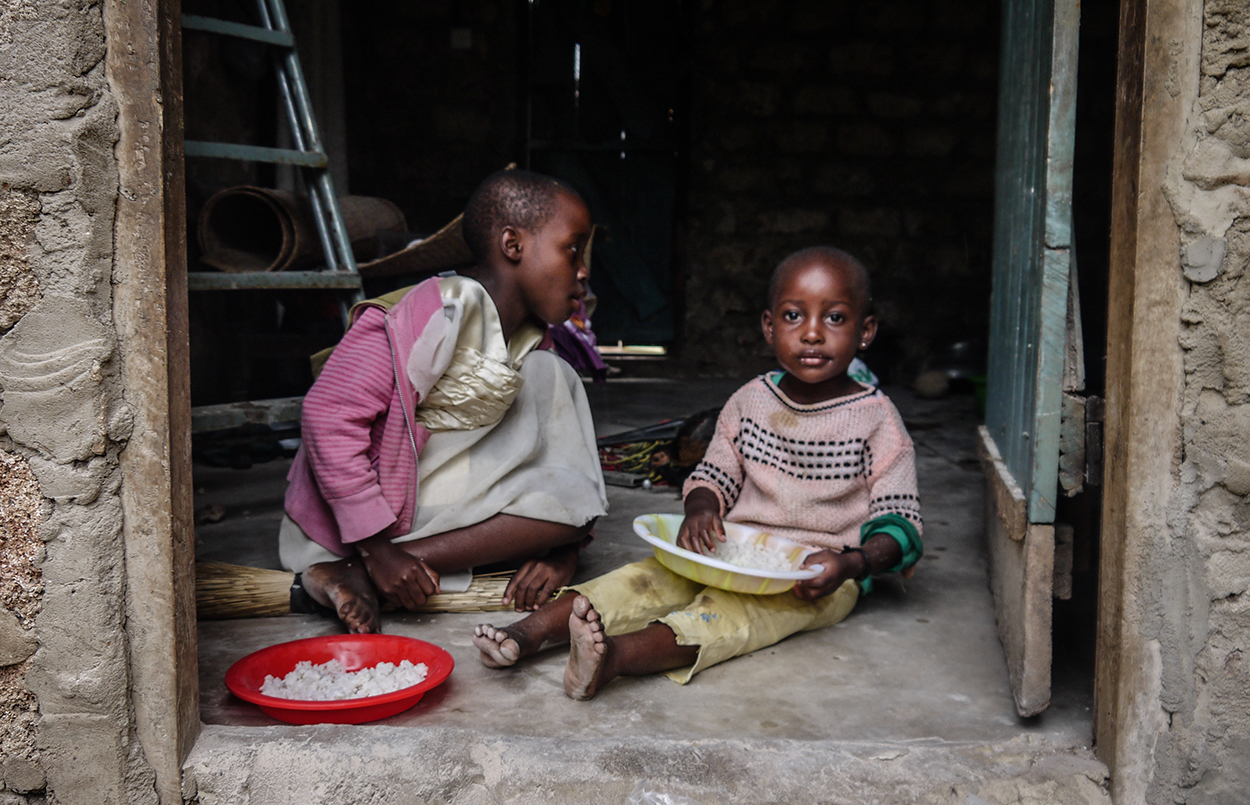 young kids eating on floor