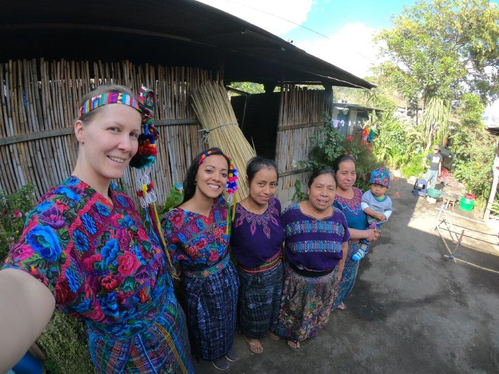 standing with host family in traditional dress