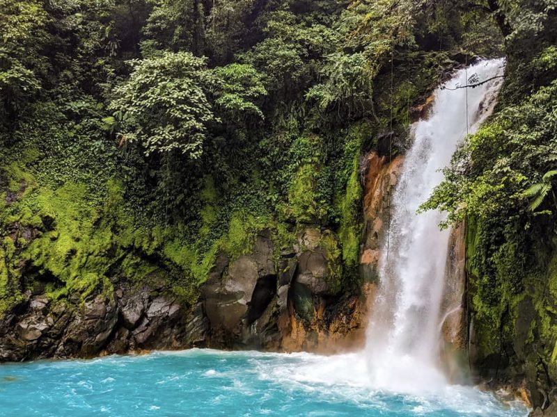 waterfall into blue pool