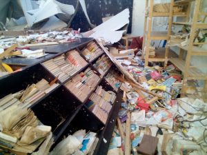 bookcase fallen in rubble