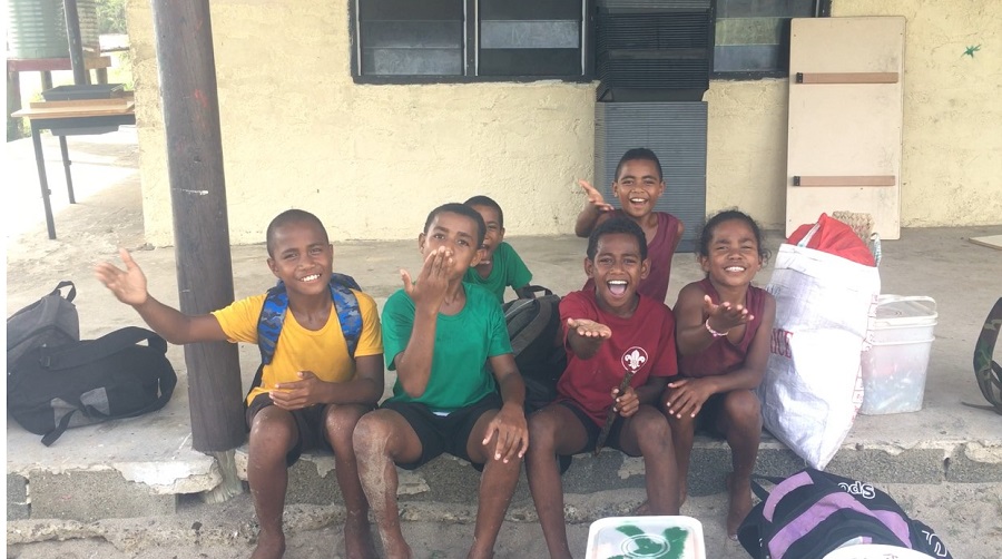 children blowing kisses at camera