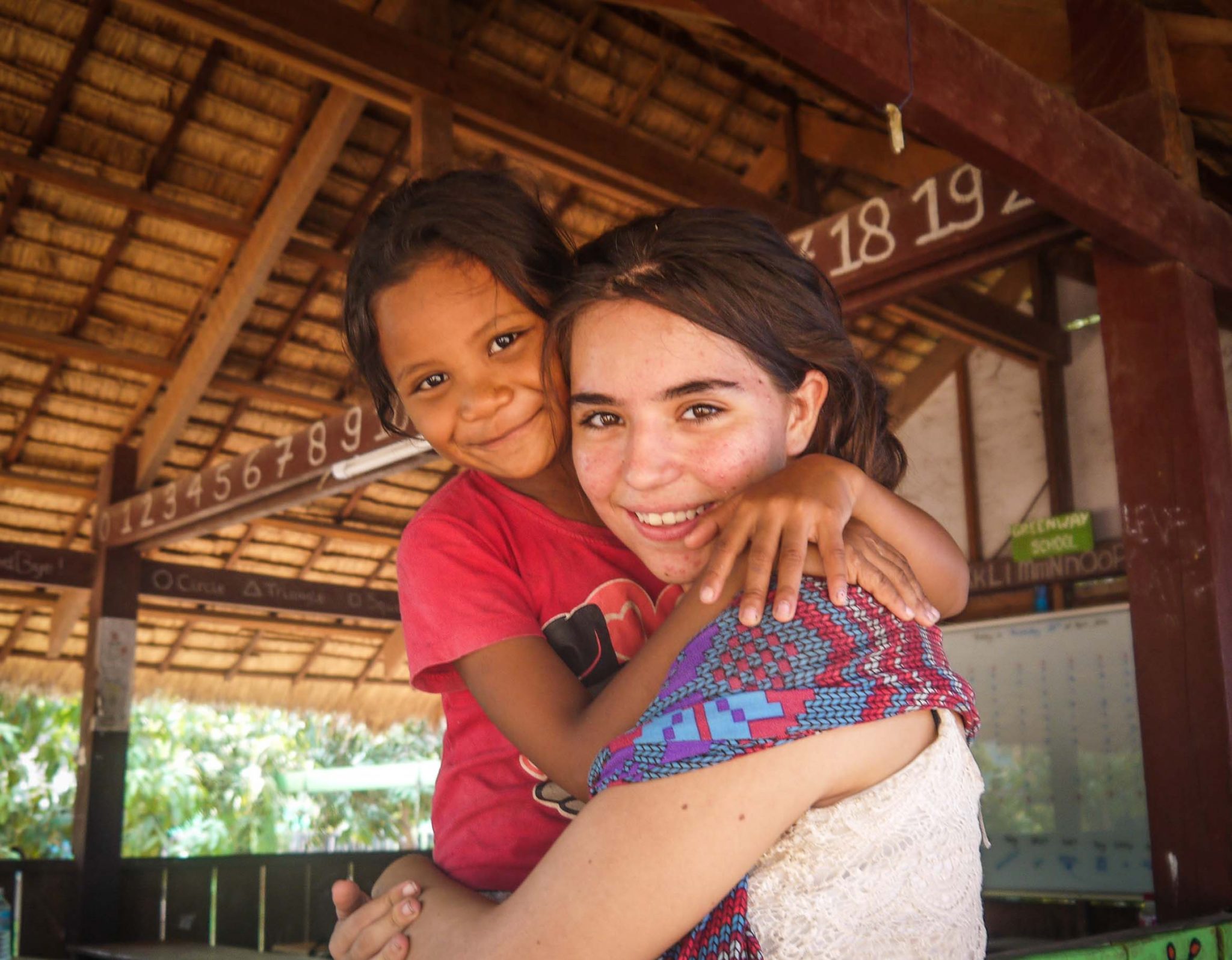 Participant and student hugging