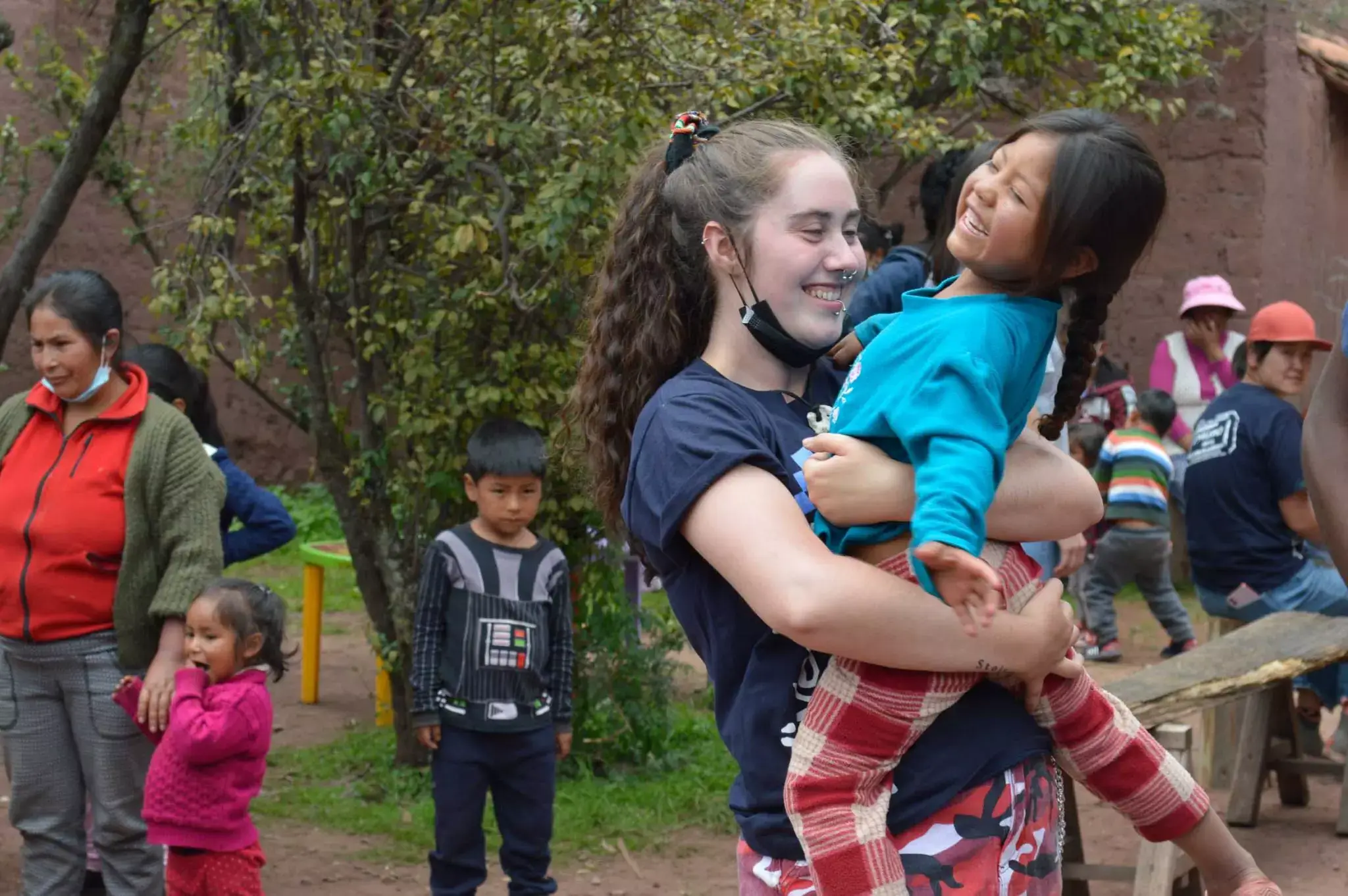 volunteer-holding-child-in-peru-4-scaled