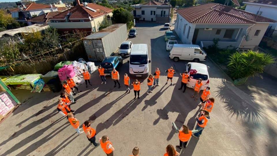 refugee volunteers making a heart shape