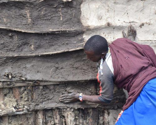 clay house building by a local Tanzania man