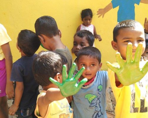 kids with paint on hands