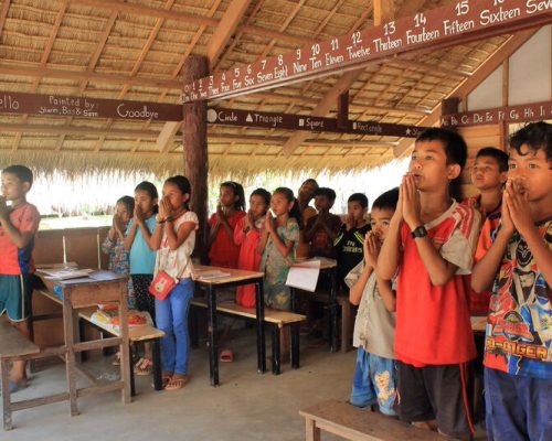 Children reciting daily prayer cambodia school