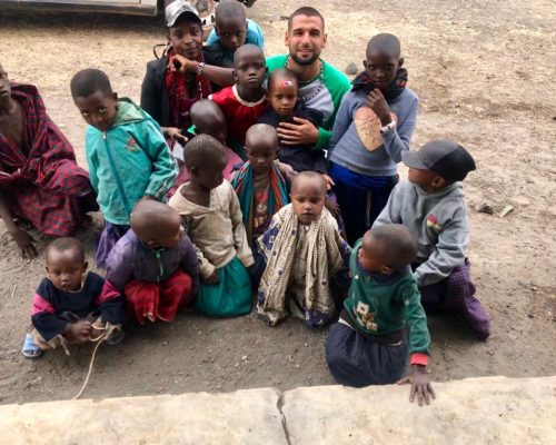 volunteers with group of kids in Tanzania