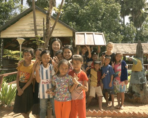 Group photo of participant with students