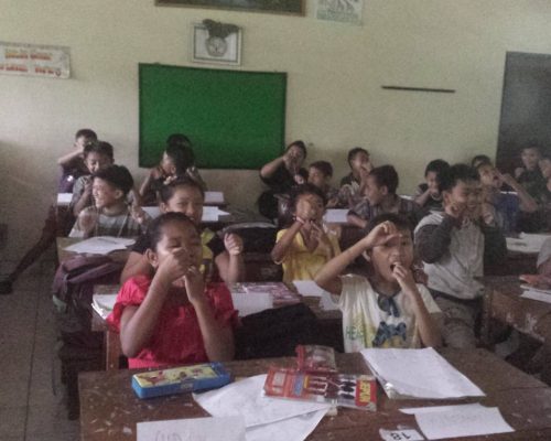 teaching children how to floss in bali