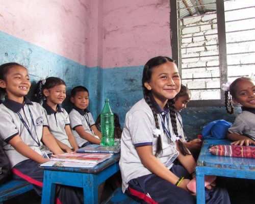 girl smiling at desk