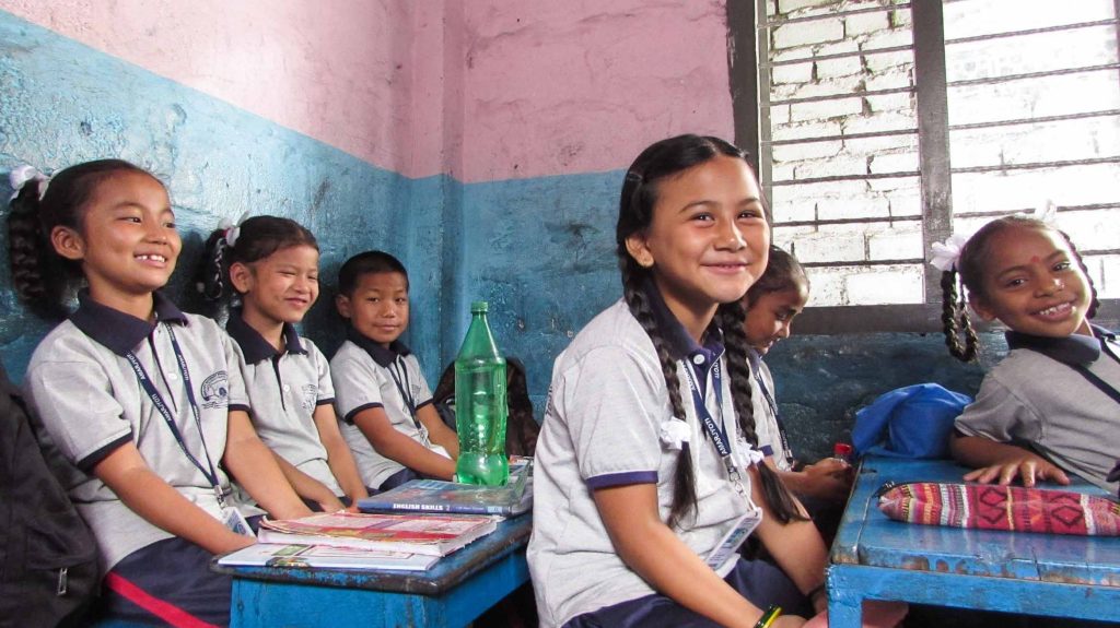 girl smiling at desk