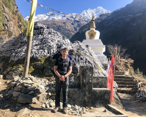 standing by monument on trek