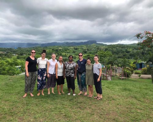 IVI volunteers in vanuatu with nice countryside in background - Copy