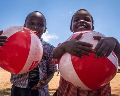 Kids holding foolball