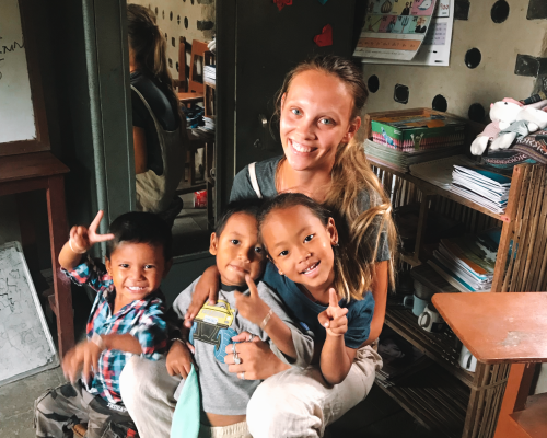 Kindergarten children with Georgina the IVI volunteer