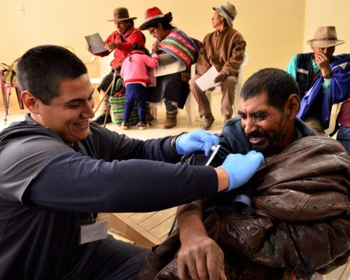 volunteer helping in local hospital clinic waiting room in peru