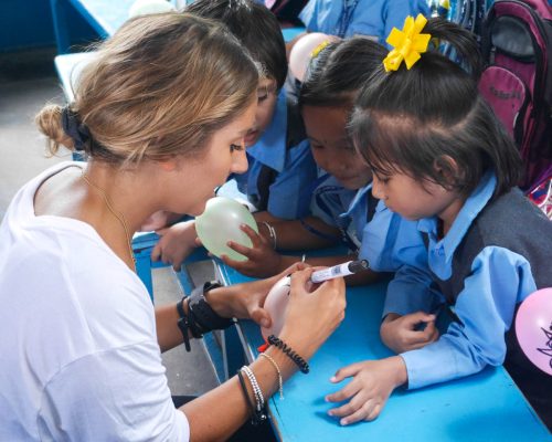 IVI Volunteer teaching Nepalese Children