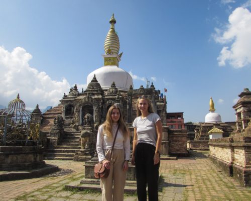 girls standing by temple