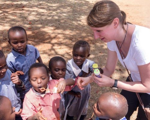 students blowing bubbles in kenya