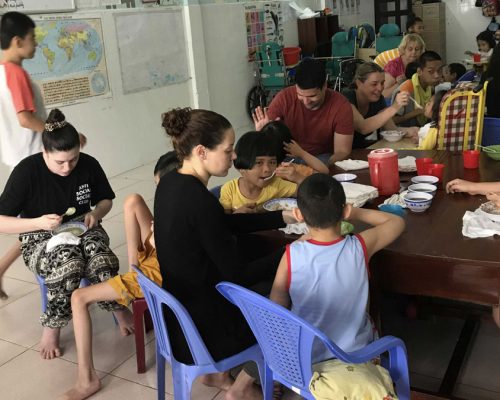 IVI volunteer feeding a child