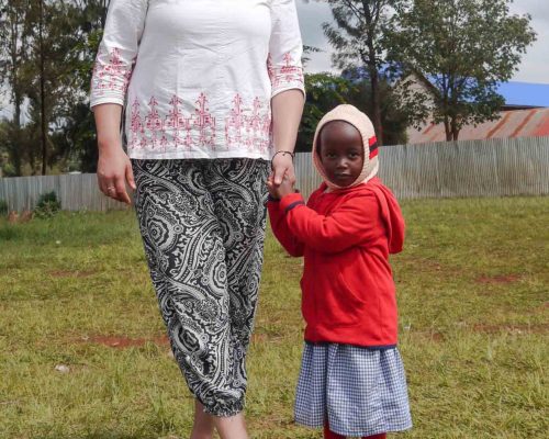 Participant holding a student's hand