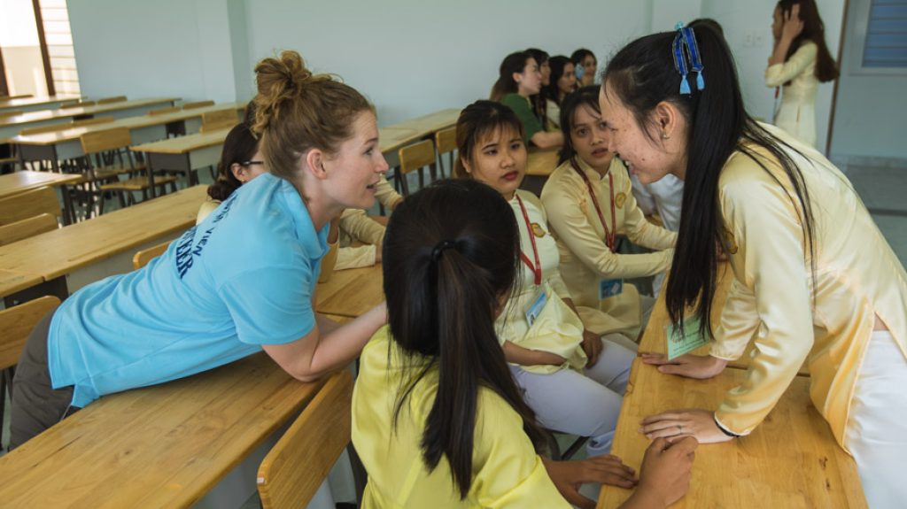 Participant talking with students- ivi volunteering