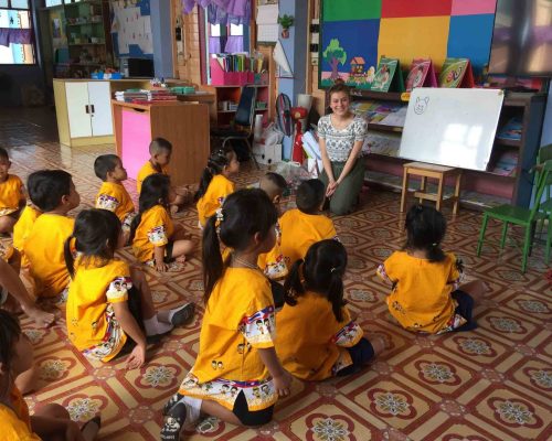 Participant teaching animal names in English with drawings