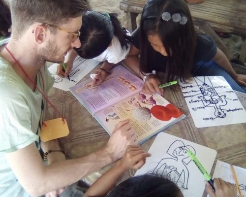 Participant teaching student about body parts