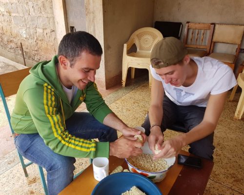 Participants preparing corn for a meal