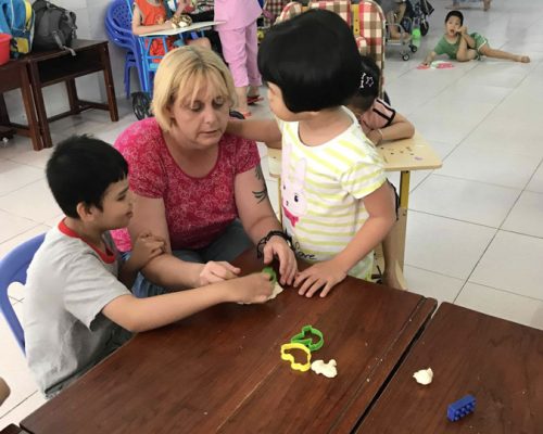 Participants teaching children making Play Dough